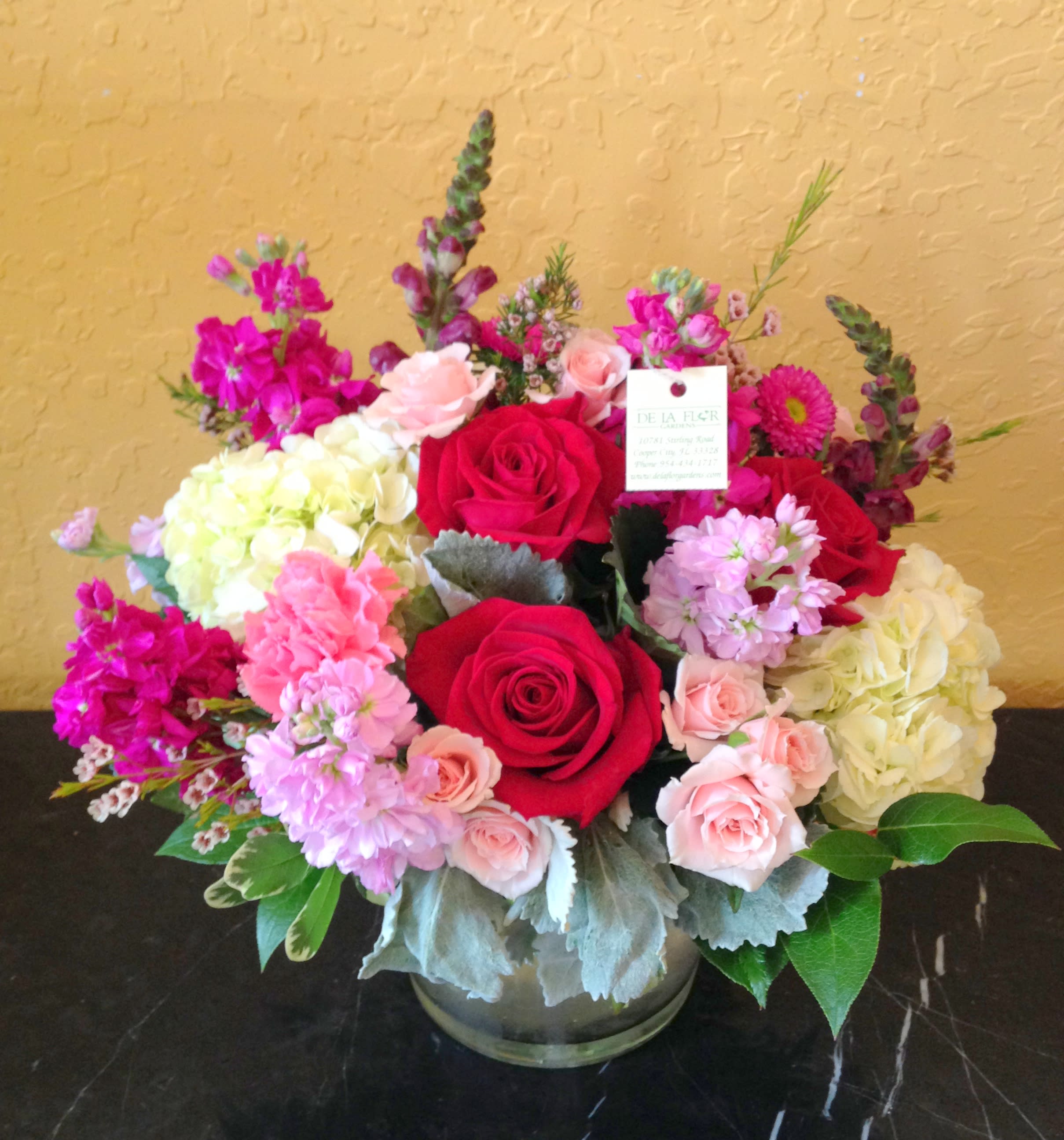 Bouquet of red and pink roses with hydrangeas in a glass vase
