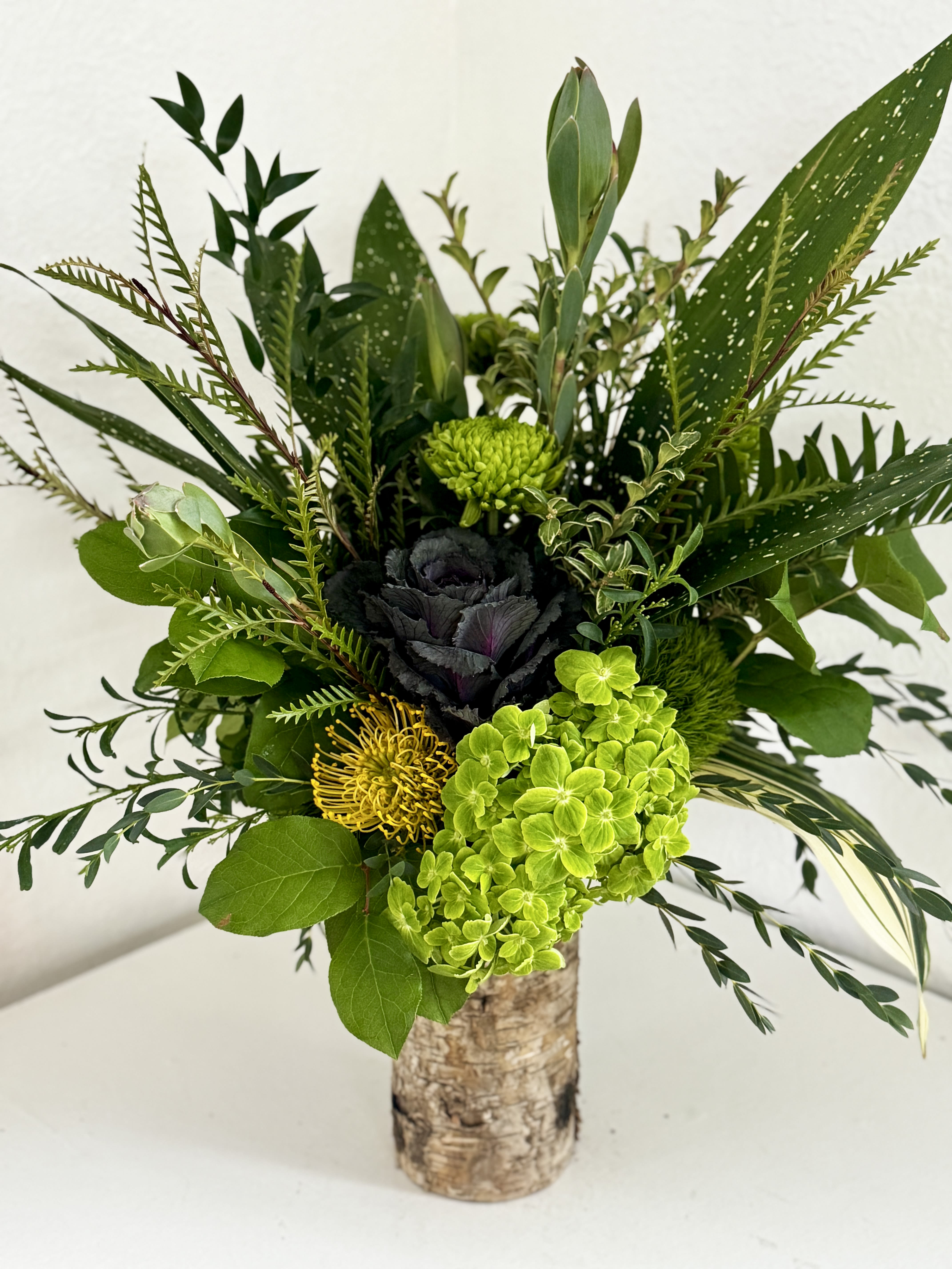 Go Green - If you're looking for something unusual and simple that makes a strong statement, try this bouquet of green flowers with a touch of yellow!
