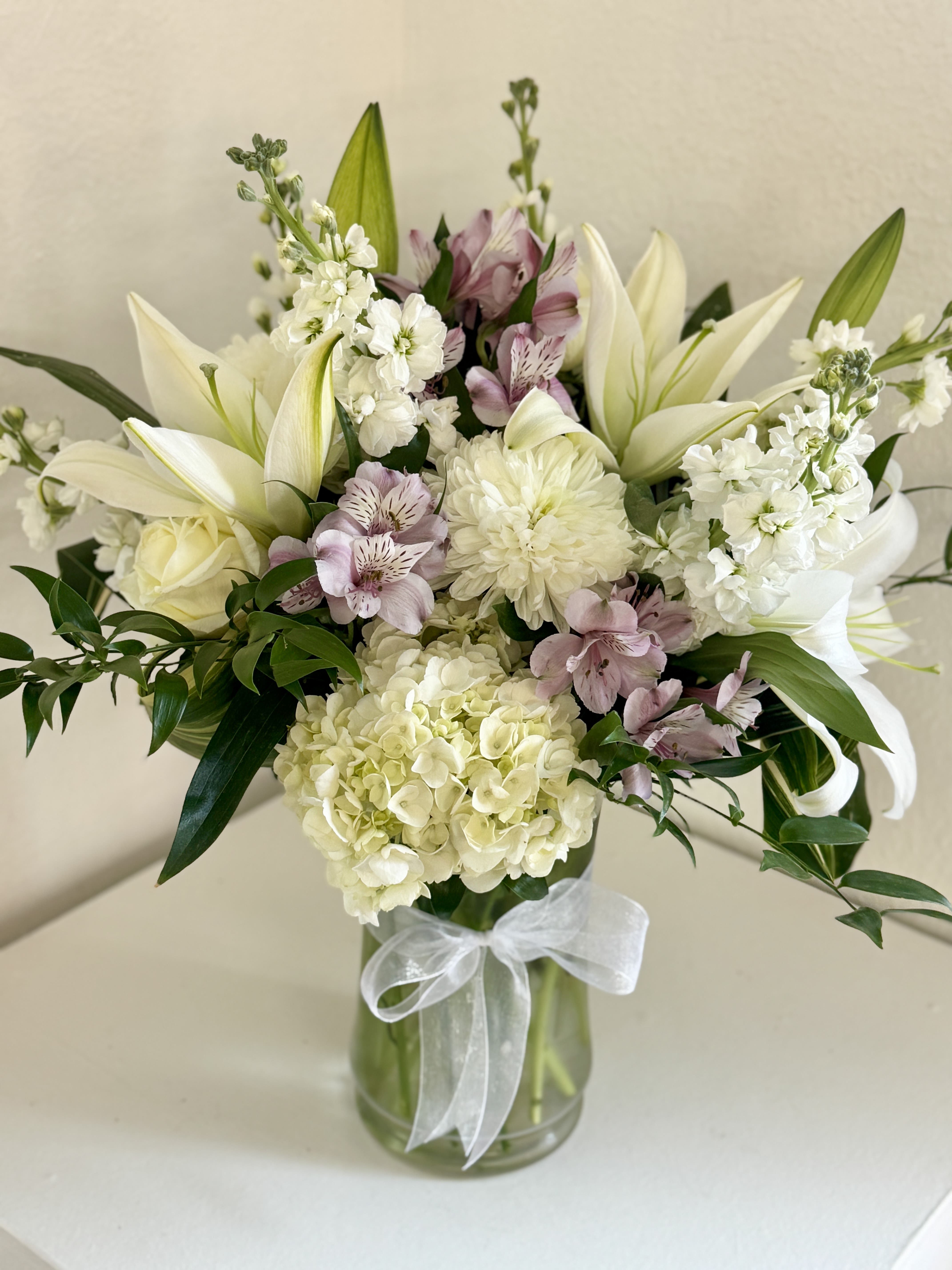 Heaven's Light - Mostly white blooms with touches of pastel hues that are soft and serene, reflecting comfort and compassion.