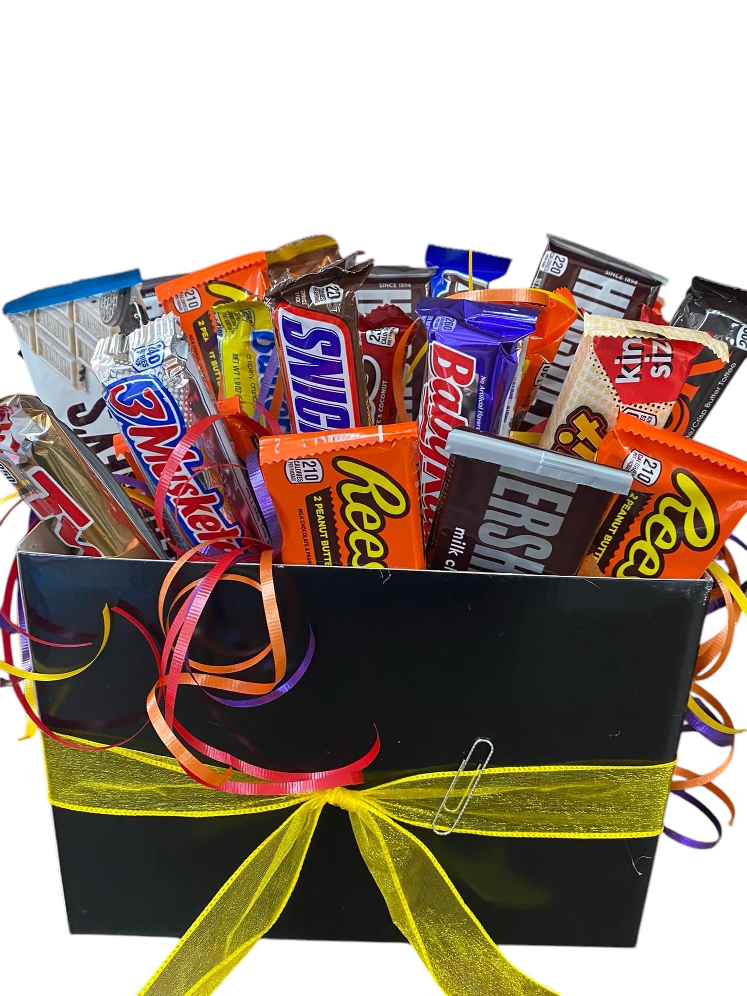 Gift box filled with assorted candy bars and ribbon