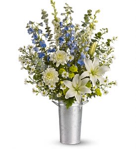 Beachside Bliss - Send someone the bliss and beauty of the beach with this sensational summer bouquet. What a great way to bring more sunshine into the home or the office. It's loaded with white asiatic lilies, dahlias, larkspur, large monte cassino asters, light blue delphinium and green button spray chrysanthemums all delivered in a summery silver pail!  Approximately 18 1/2" W x 27" H Orientation: One-Sided  As Shown : T162-1A Deluxe : T162-1B Premium : T162-1C