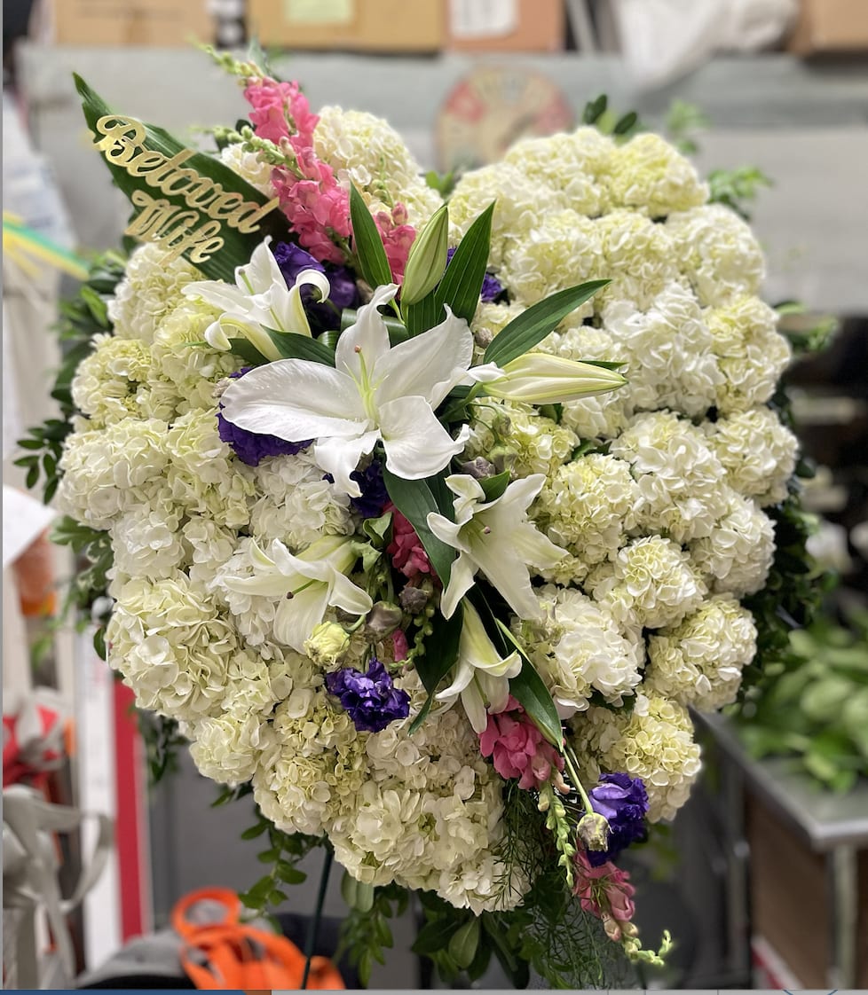 Large standing floral spray with white lilies and cream hydrangeas