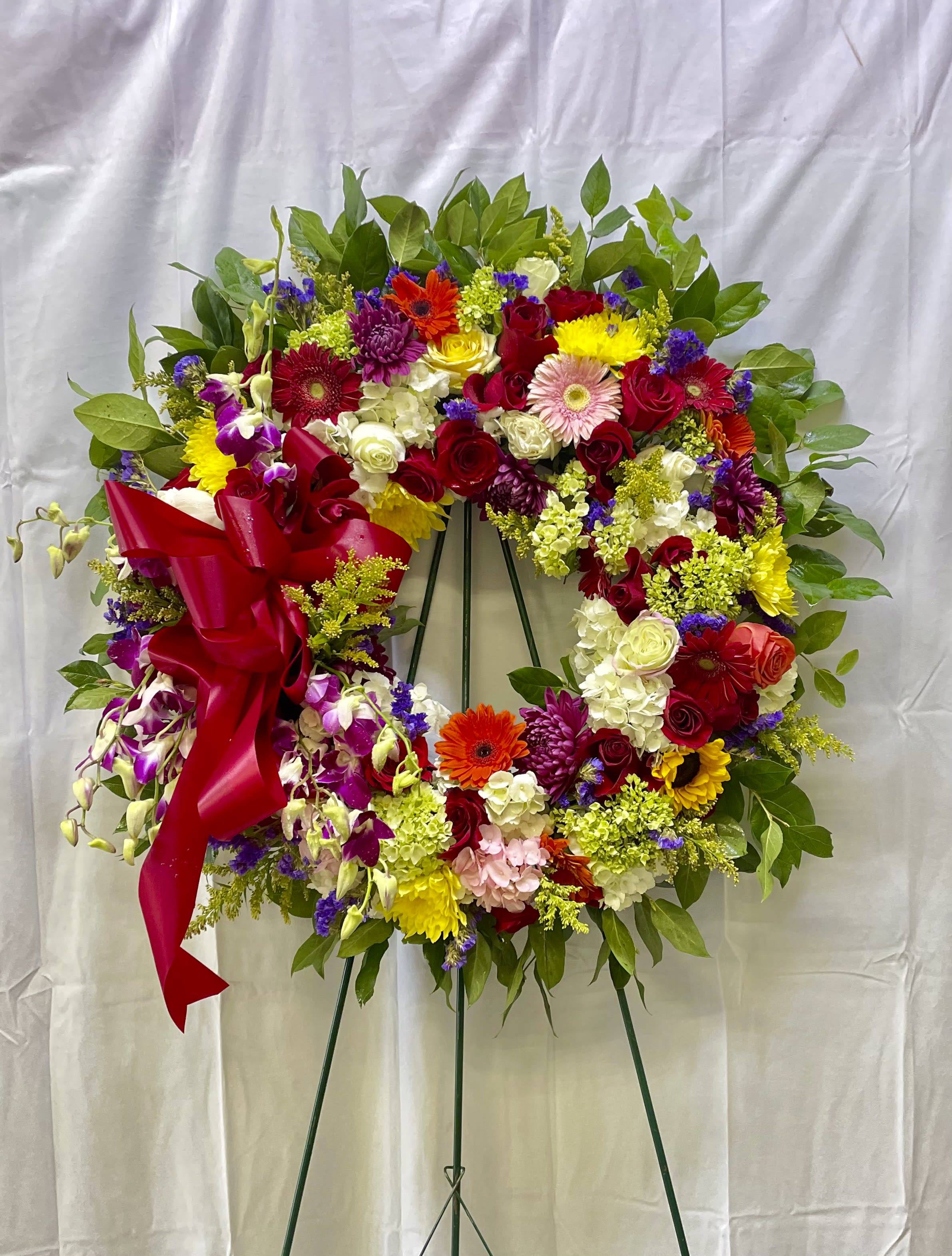 Beautiful and Bright (Deluxe Shown) - Elegantly designed with seasonal flowers with burst of difference colors  