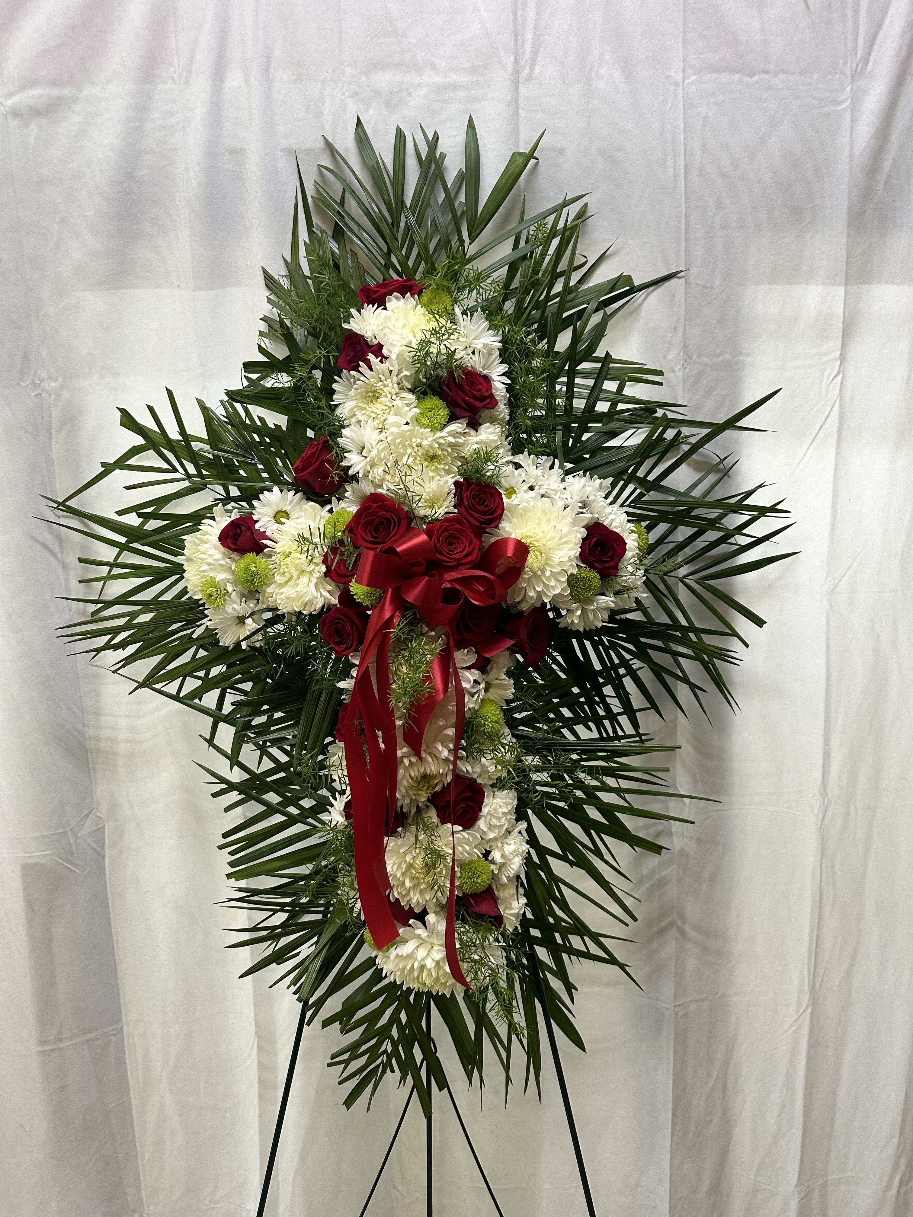 Standing floral spray with red roses and white chrysanthemums on an easel