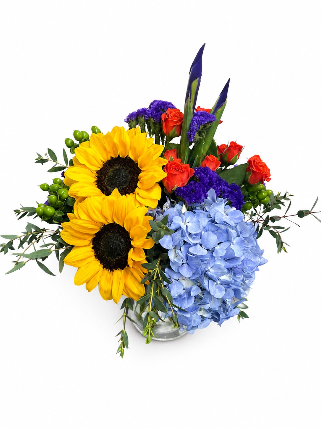 Sunny Days - Perfect for a desk, side table, or office reception area, this bright and cheerful floral arrangement is designed to bring a touch of sunshine to any day. Featuring vibrant sunflowers, delicate spray roses, lush hydrangeas, and striking iris blooms, this compact arrangement is artfully designed in a classic gathering vase for a fresh and welcoming presentation.  The colorful blend of seasonal flowers creates a joyful display that is ideal for birthdays, get-well wishes, thank-you gifts, or simply letting someone know you're thinking of them. Its compact size makes it a wonderful choice for offices, hospital rooms, apartments, and smaller spaces where a burst of color and beauty can make a big impact.  Handcrafted with care and attention to detail, each arrangement is created using the freshest flowers available. Substitutions may occasionally be necessary to ensure the highest quality and freshness while maintaining the overall style and color palette of the design.  We proudly offer local flower delivery throughout Smyrna, Mableton, Marietta, Austell, Powder Springs, and Atlanta, Georgia.