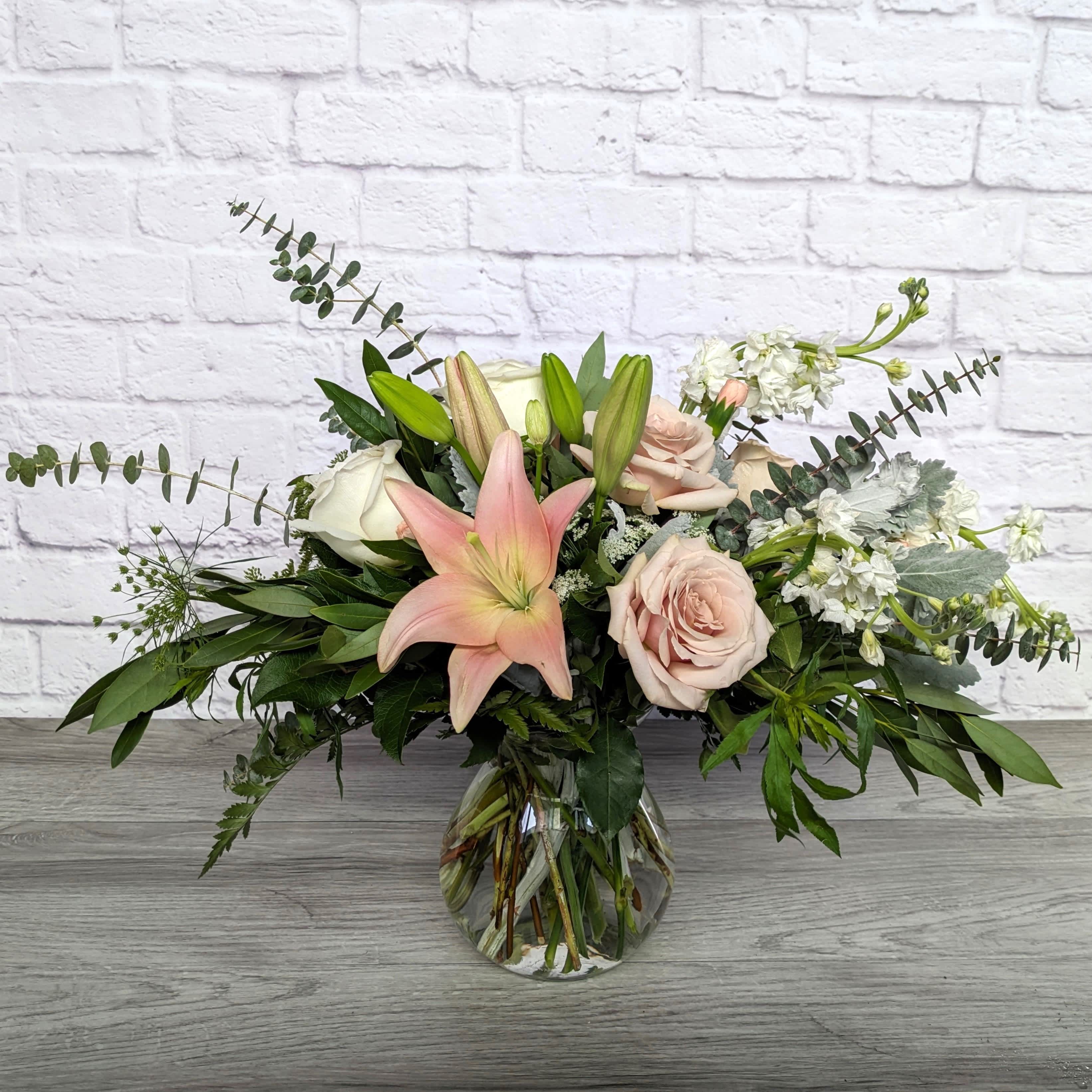 Dreamy Blush - Dreamy Blush is A Ladybug Floral exclusive bouquet. High end roses in blush and white are complemented by soft pink lilies, frothy queen anne's lace, fragrant stock, peach mini carnations, spiral eucalyptus, bay leaf, and dusty miller. Presented in a 7" Lula Vase.  All Round Orientation 15"H X 24"W 