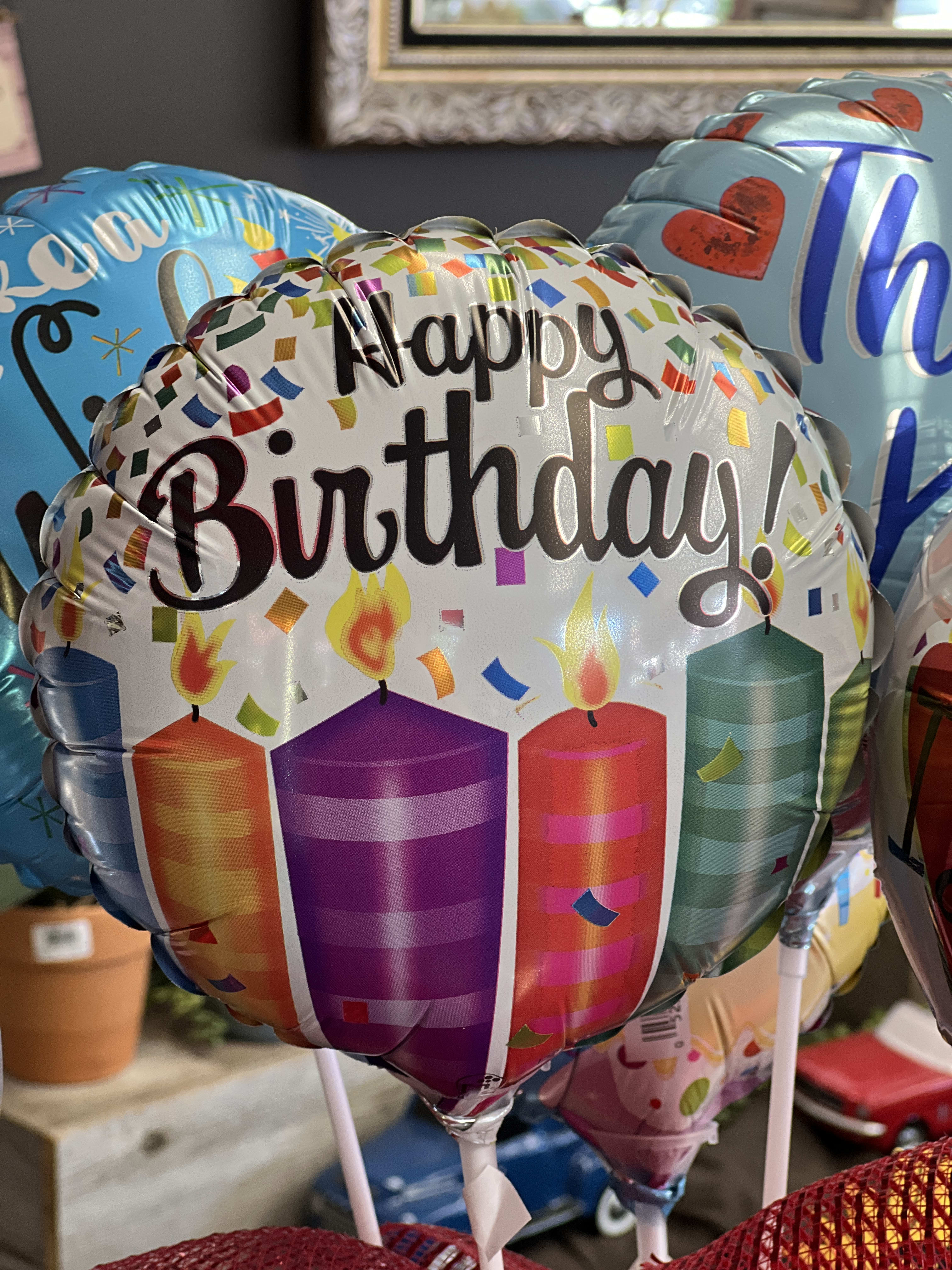 Birthday balloons with candles and confetti