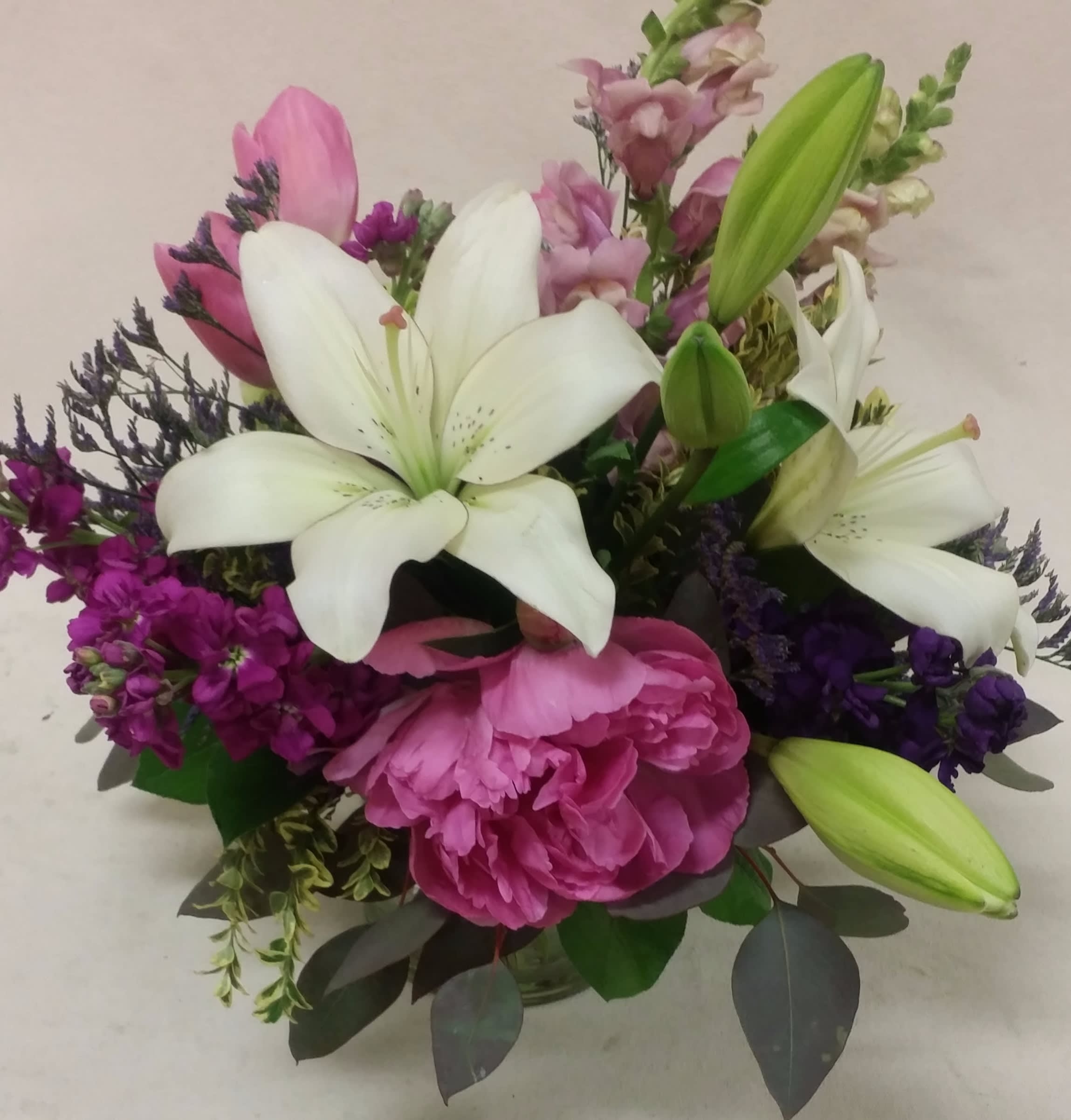 "Magenta Melody" Bouquet - Purples, hot pink, and magenta blossoms are highlighted with a creamy Asiatic lily. What a show!