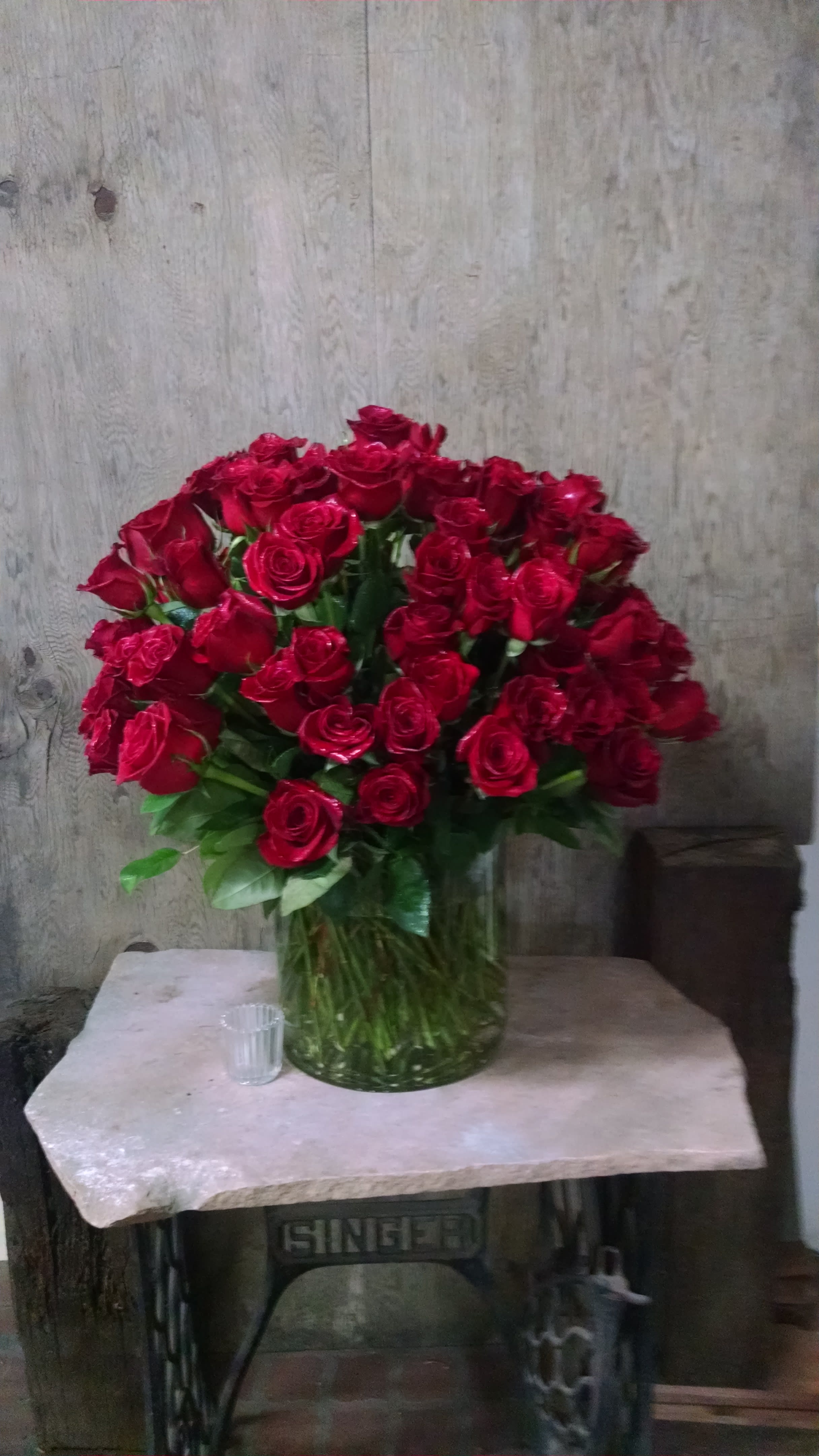 Large bouquet of red roses in a clear glass vase