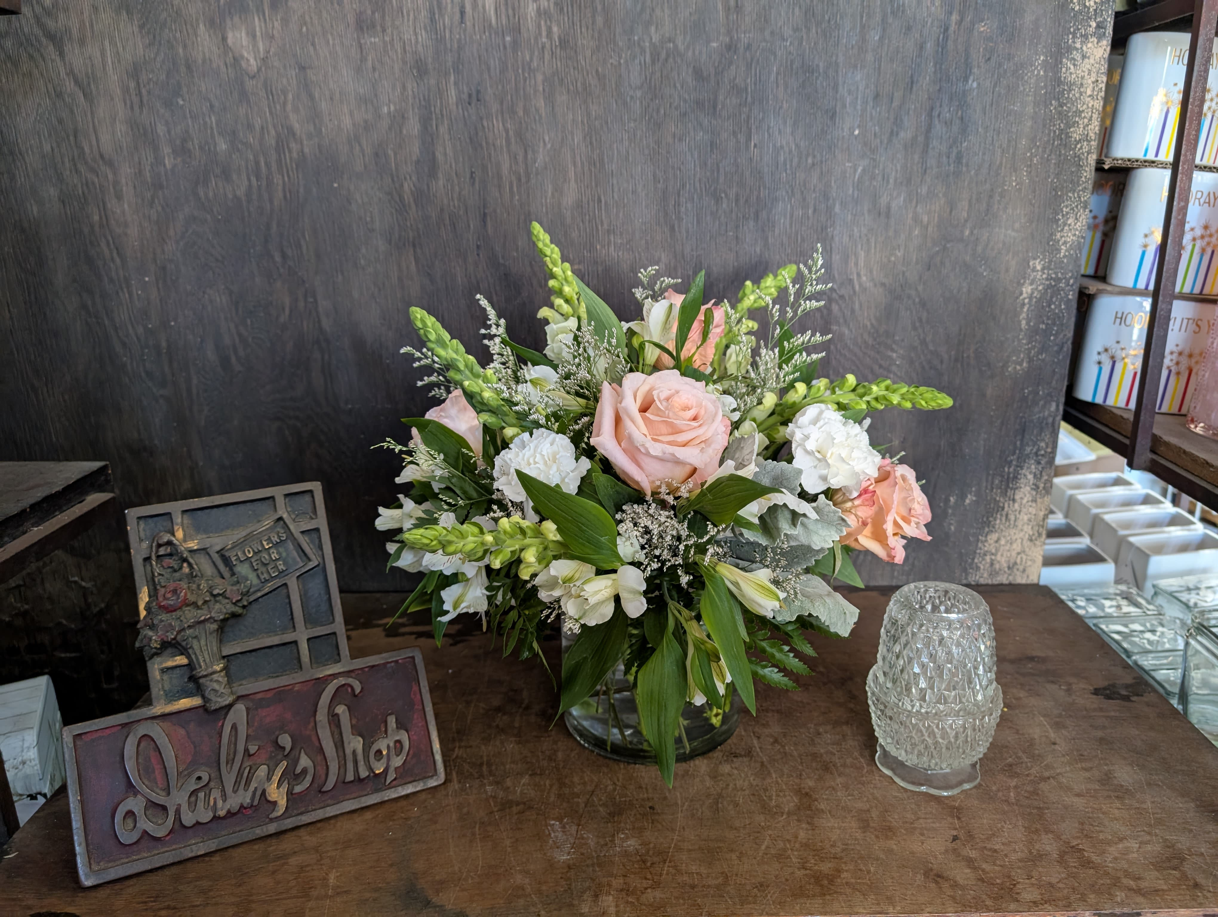 Pink and white floral arrangement in a glass vase