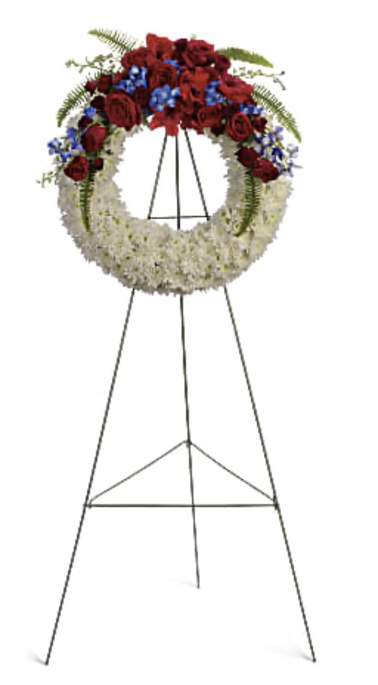 Standing funeral wreath with red and white flowers on an easel