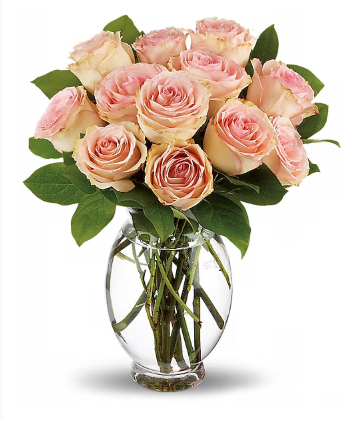Pink and cream roses arranged in a clear glass vase