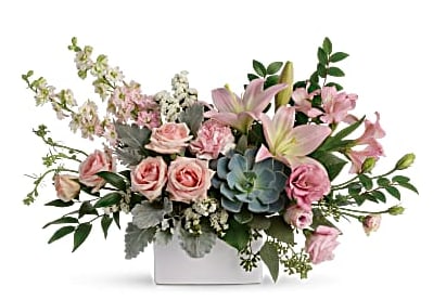 Low pink rose and lily arrangement with a succulent in a white rectangular vase