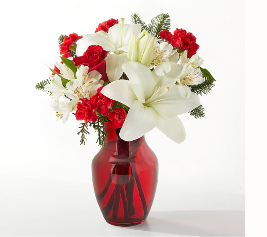 Red and white bouquet in a red glass vase