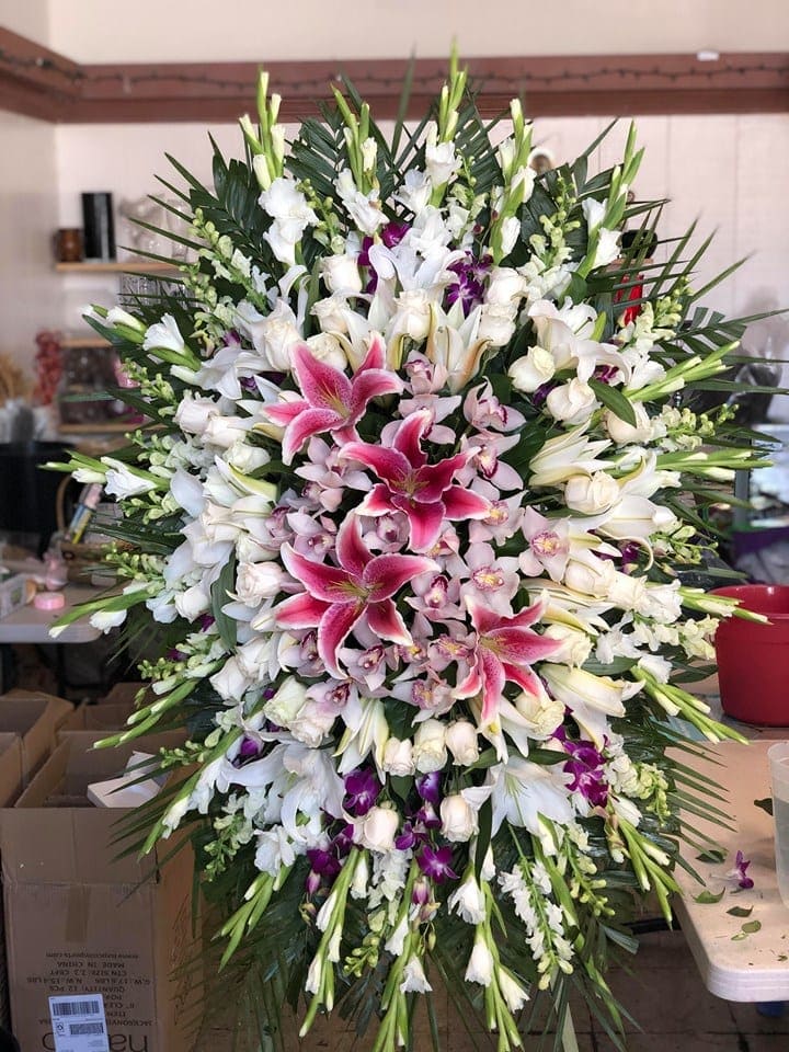 Large standing spray of white and pink lilies with orchids