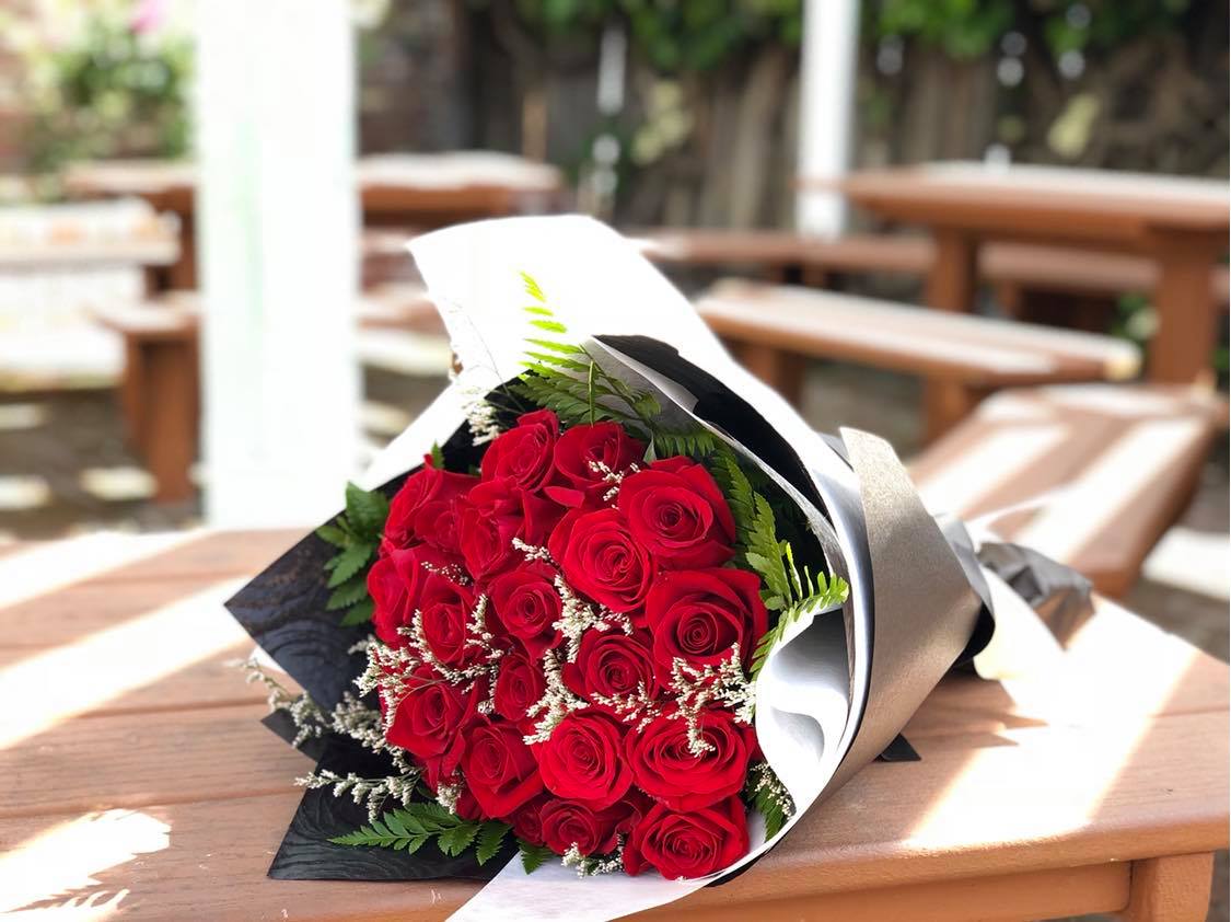 Bouquet of red roses wrapped in black and white paper