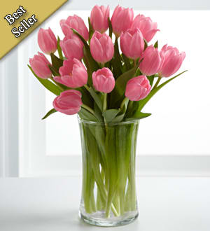 Pink tulips arranged in a clear glass vase