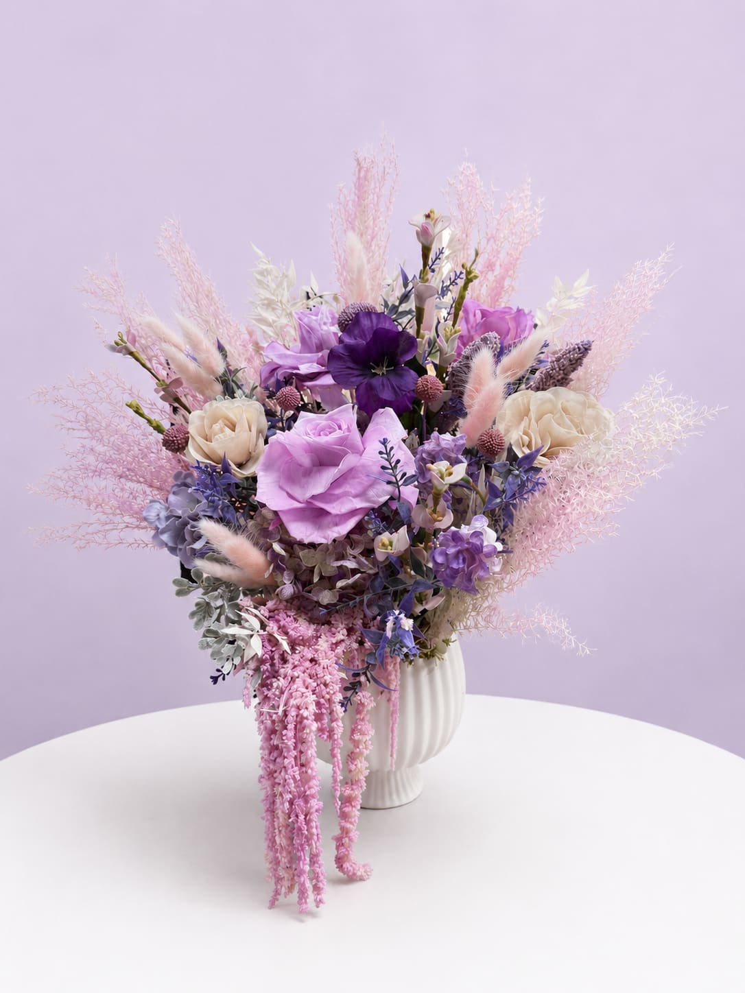 Lavender and pink floral arrangement in a white vase