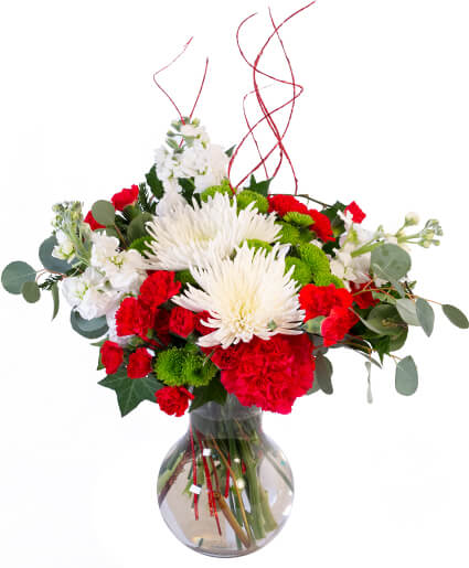 Red and white flower arrangement in a clear glass vase