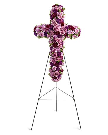 Purple and pink floral cross on a metal stand