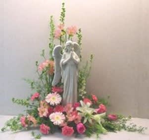 Angel statue surrounded by pink and white flowers in a floral display