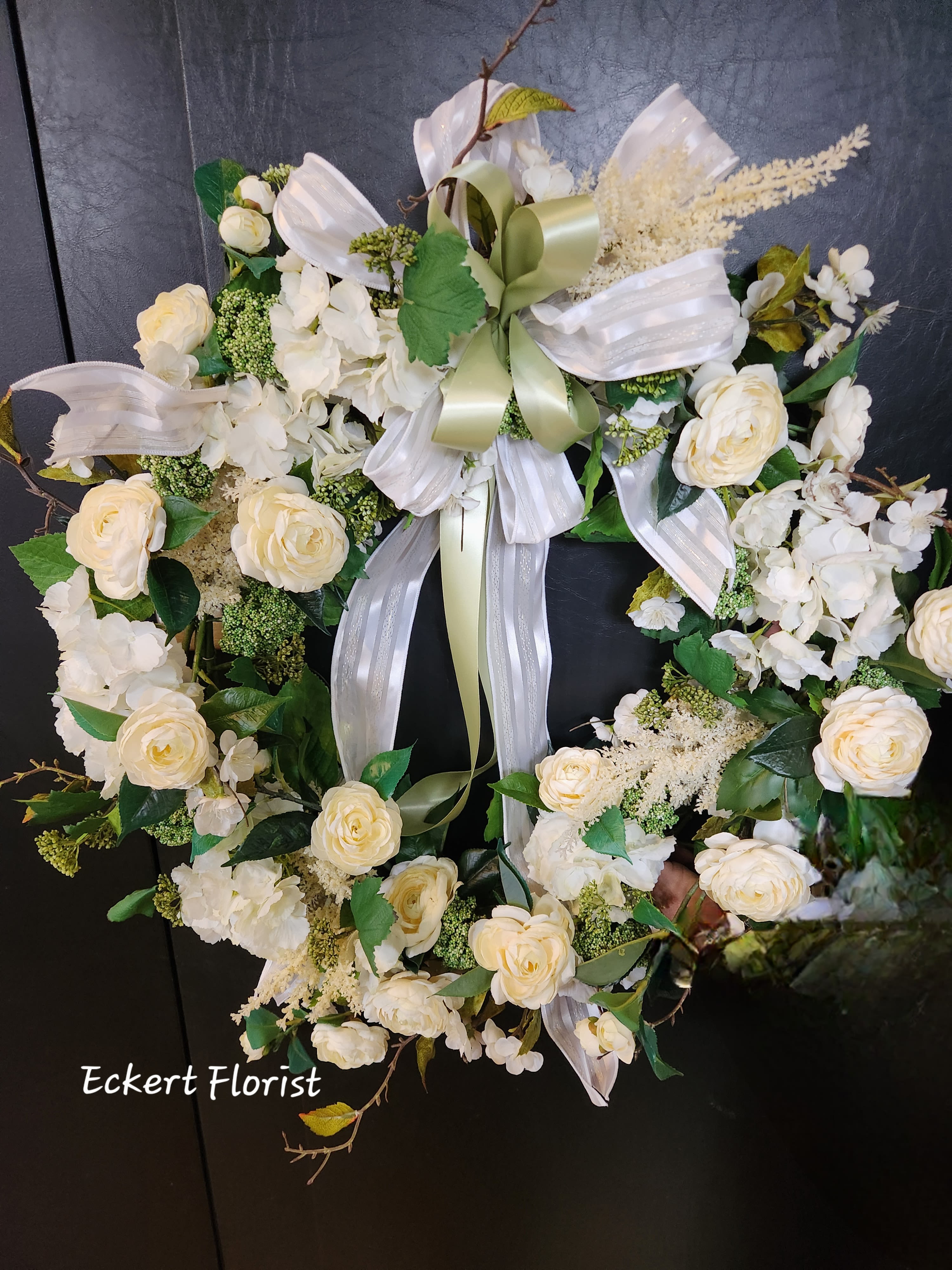 Eckert Florist 30" Artificial White Wreath  - This large wreath is created with an assortment of white silk flowers and greens, perfect for any decor. Variety of white flowers may vary. Approx. 30" Diameter