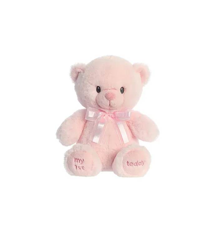 Soft pink teddy bear plush with a satin ribbon bow and embroidered paws