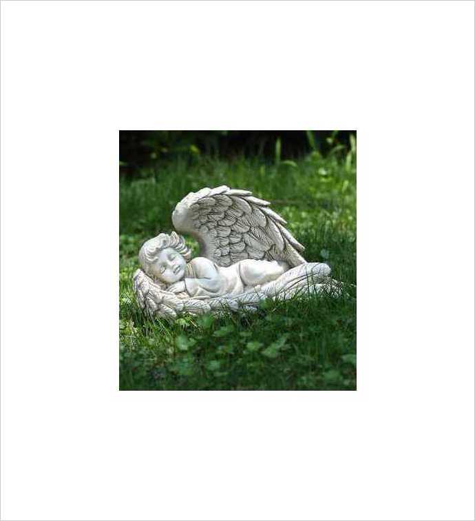 White sleeping angel statue lying on grass