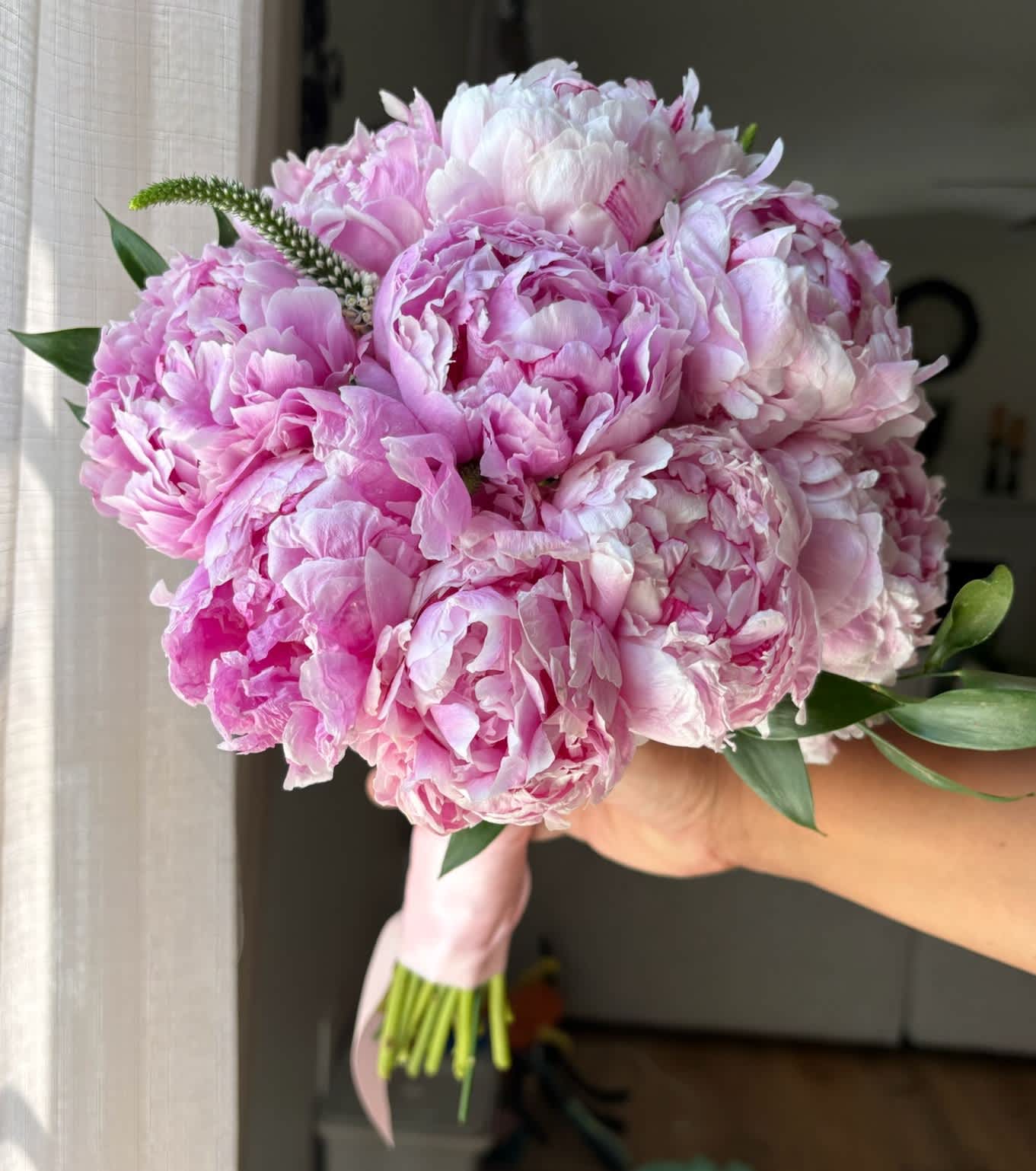 Pink peony bouquet with a pale pink ribbon wrap
