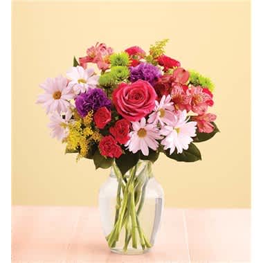  Fun &amp; Flirty - Whether it’s a new crush or a long-time love, here’s the perfect gift for getting a little flirty! Our expert florists put plenty of TLC into creating this hand-designed bouquet of roses, carnations and more in playful colors that really pop. Send it to your sweetie and you’re sure to get plenty of XOXO in return! • Our florists hand-design each arrangement, so colors, varieties and container may vary due to local availability • Fresh arrangement of hot pink roses, purple carnations, hot pink mini carnations, lavender daisy poms, purple alstroemeria, athos poms, solidago and salal • Gathered in a stylish clear glass vase; measures 8"H • Large arrangement measures approximately 16"H x 13"W • Medium arrangement measures approximately 15"H x 11.5"W • Small arrangement measures approximately 14"H x 10"W