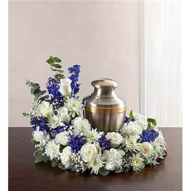 White and blue floral wreath around a metal urn
