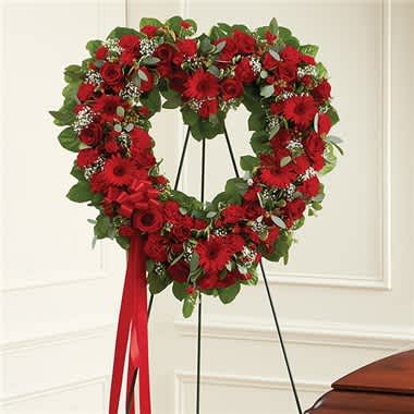Always Remember™ Floral Heart Tribute- Red - The love for someone who has passed away lives on forever in the hearts of those left behind. This sentiment is best captured with our standing, open heart-shaped red floral arrangement. Handcrafted by our caring florists with an assortment of radiant red blooms, it is a magnificent tribute fitting for the funeral services. •All-red open heart-shaped arrangement of roses, spray roses, Gerbera daisies, carnations, mini carnations, hypericum; accented with baby’s breath and soft, lush greenery •Arrangement is designed on an easel and accented with satin ribbon •Measures approximately 26"H x 28"W without easel •Appropriate for the funeral home •Our florists use only the freshest flowers available, so colors and varieties may vary