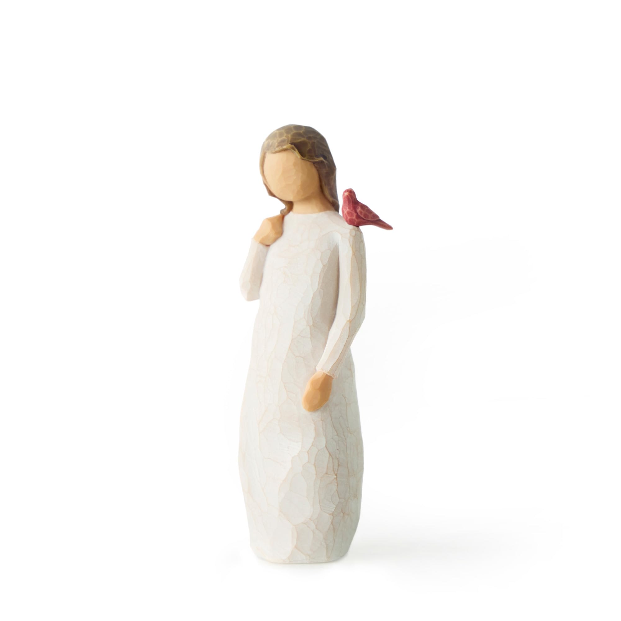 Small carved figurine of a girl in a white dress with a red bird on her shoulder