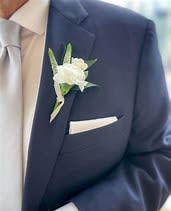 White boutonniere on a navy suit jacket