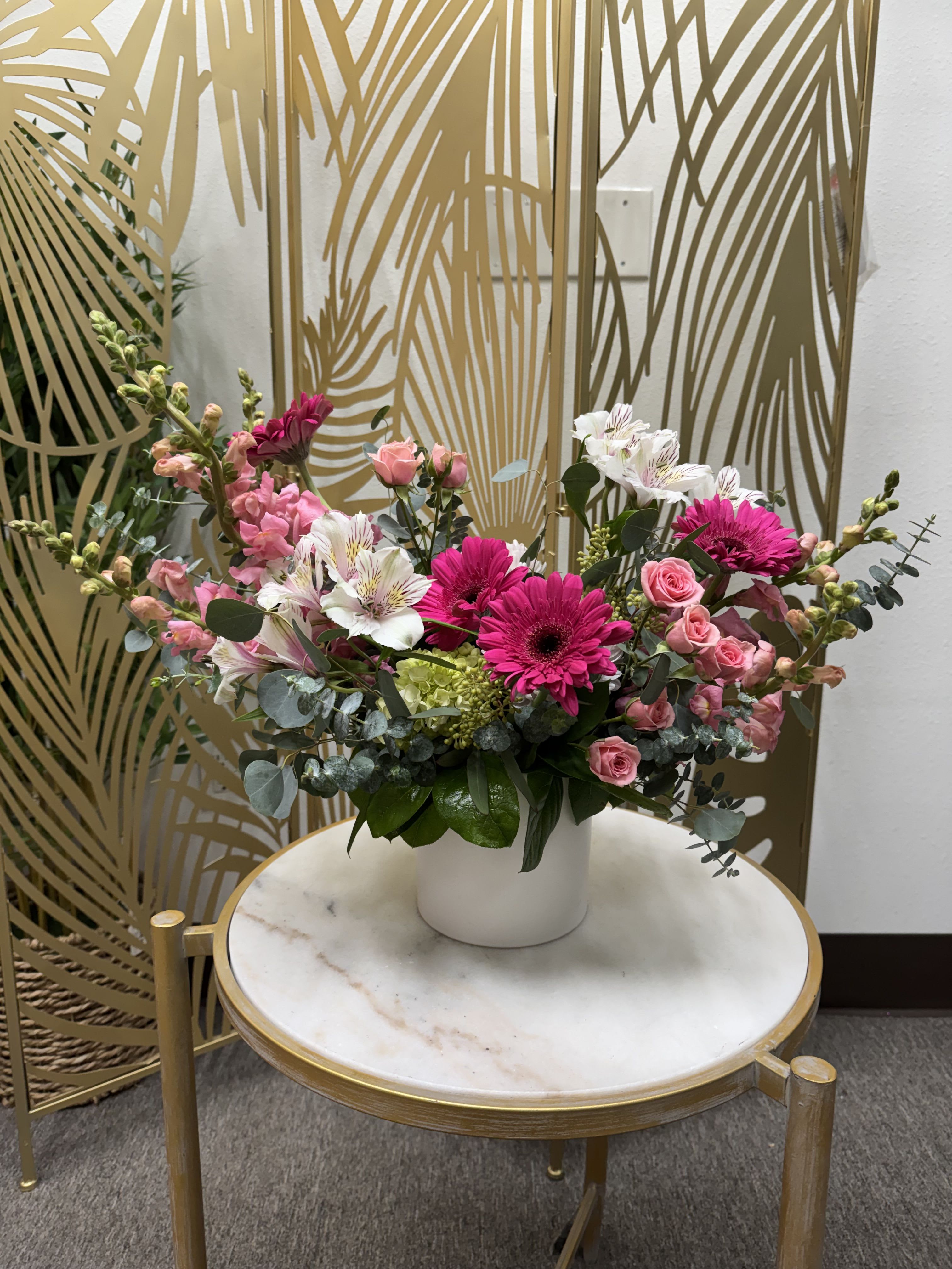 Pink and white mixed flower arrangement in a white vase