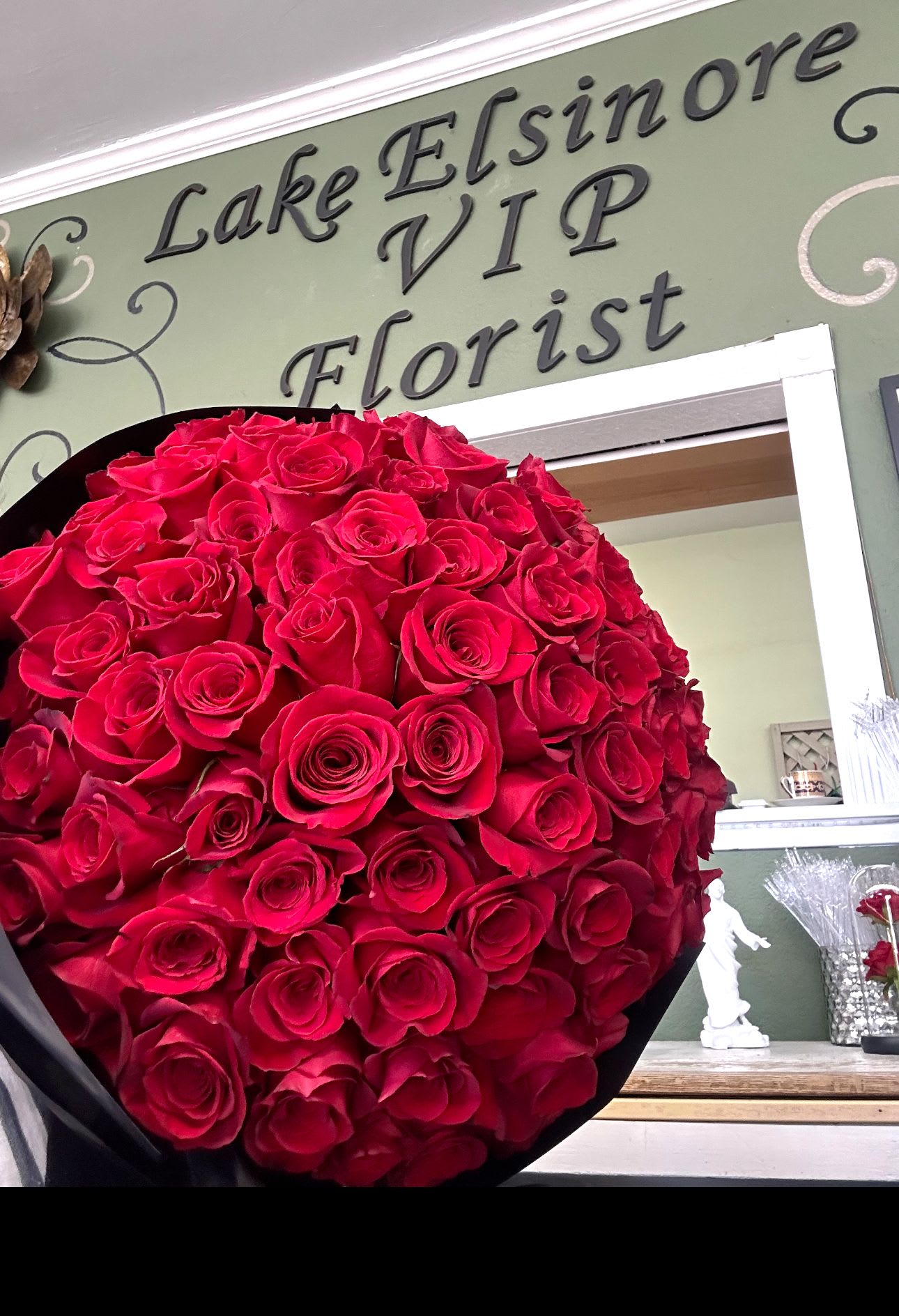 Large bouquet of red roses wrapped in black paper