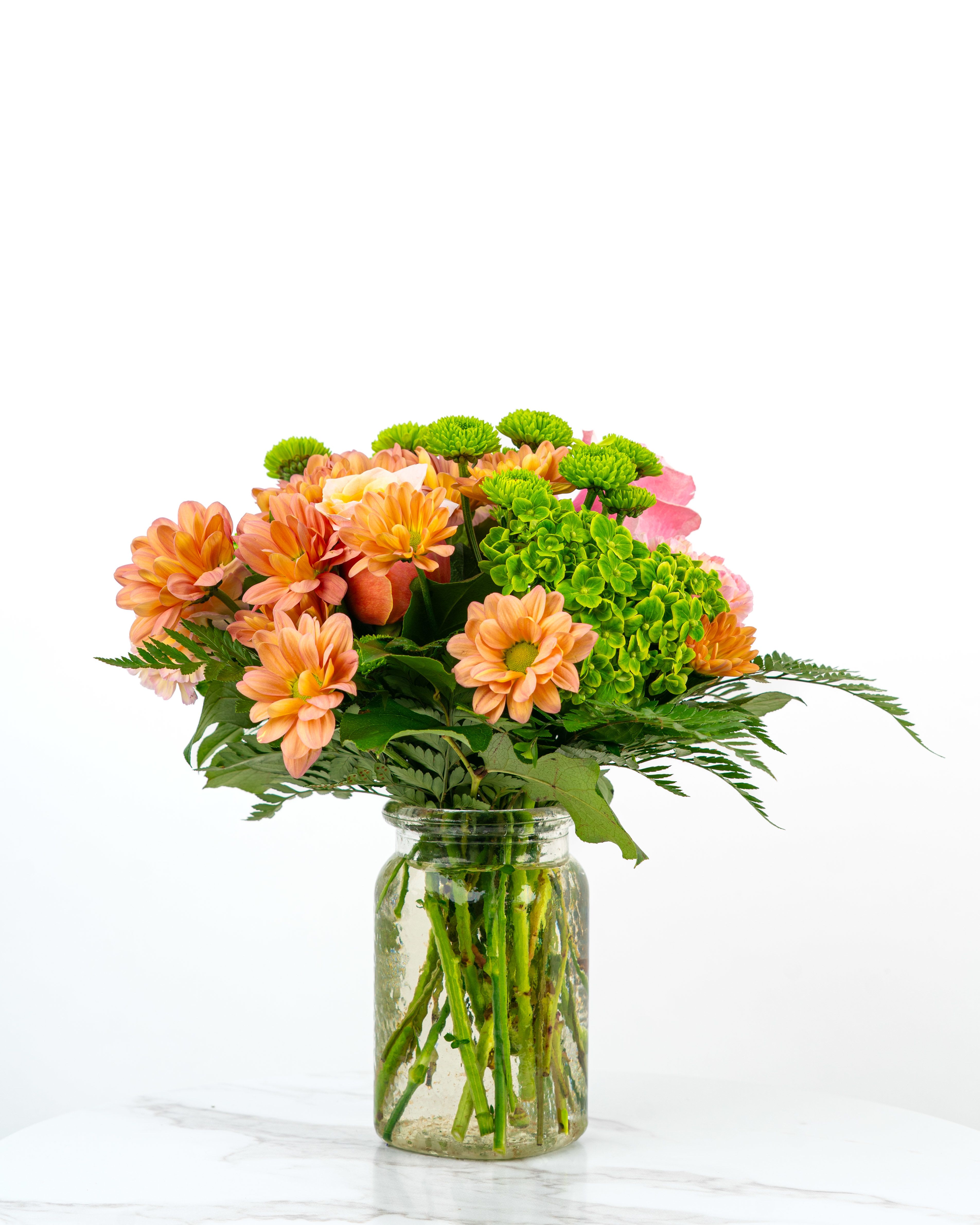 Our Birthday Collection: Warmest Blooming Birthday - Our Blooming Birthday Wishes Collection celebrates birthdays with bright blooms in cheerful hues. The Warmest Blooming Birthday Wishes arrangement is bursting with warm-tone colors and charm to make someone's special day unforgettable. Send birthday wishes with this one of a kind arrangement styled just for your order. Because we always use the freshest blooms, your final arrangement may not look exactly as pictured due to seasonal availability.