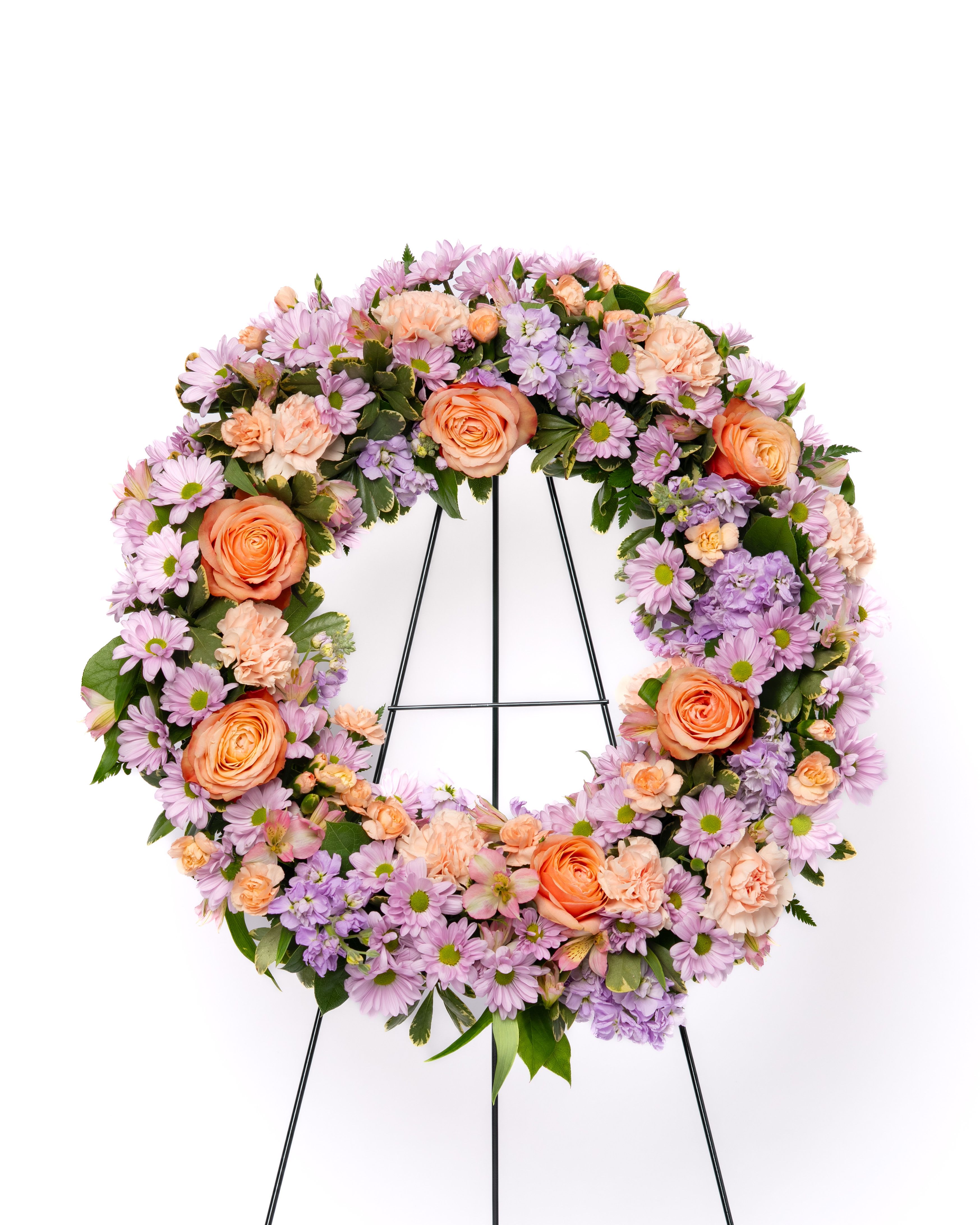 Our Hope Collection: 18" Open Wreath in Pastels - Soft and comforting, this pastel wreath is designed to bring a gentle sense of warmth and remembrance. Featuring a harmonious blend of delicate tones, it offers a more personal and uplifting expression of sympathy.  A beautiful choice for celebrating a life with tenderness and grace.  Each arrangement is thoughtfully designed using the freshest blooms available. Flower varieties may vary based on availability while maintaining the overall style, color palette, and value.  Approximate Dimensions of Floral Tribute: 48" tall x 24" wide  Color &amp; Customization: Need a custom color scheme? Contact us for more information. Our most popular palettes include whites, whites and greens, whites and blues, pinks and whites, pastel shades, and colorful designs.  Delivery: All sympathy pieces are hand-delivered by the Schultz Floral team.