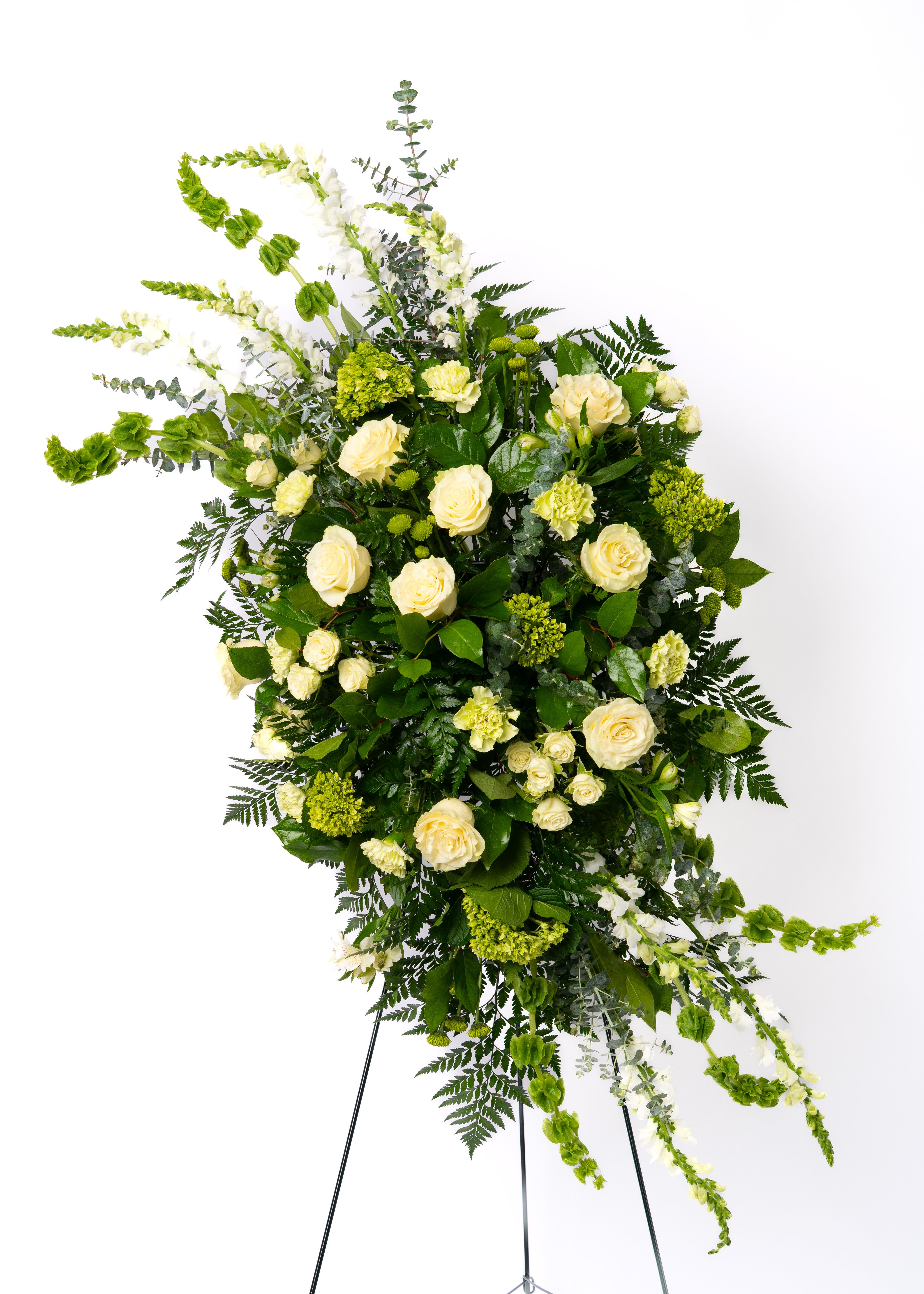 Our Gentle Thoughts Collection: Green &amp; White Easel Spray - Elegant and timeless, this white and green spray offers a clean, natural aesthetic. Designed with texture and balance for a refined and peaceful tribute.  Each arrangement is thoughtfully designed using the freshest blooms available. Flower varieties may vary based on availability while maintaining the overall style, color palette, and value.  Approximate Dimensions of Floral Tribute: 80" tall x 42" wide on easel.  Color &amp; Customization: Need a custom color scheme? Contact us for more information. Our most popular palettes include whites, whites and greens, whites and blues, pinks and whites, pastel shades, and colorful designs.  Delivery: All sympathy pieces are hand-delivered by the Schultz Floral team.