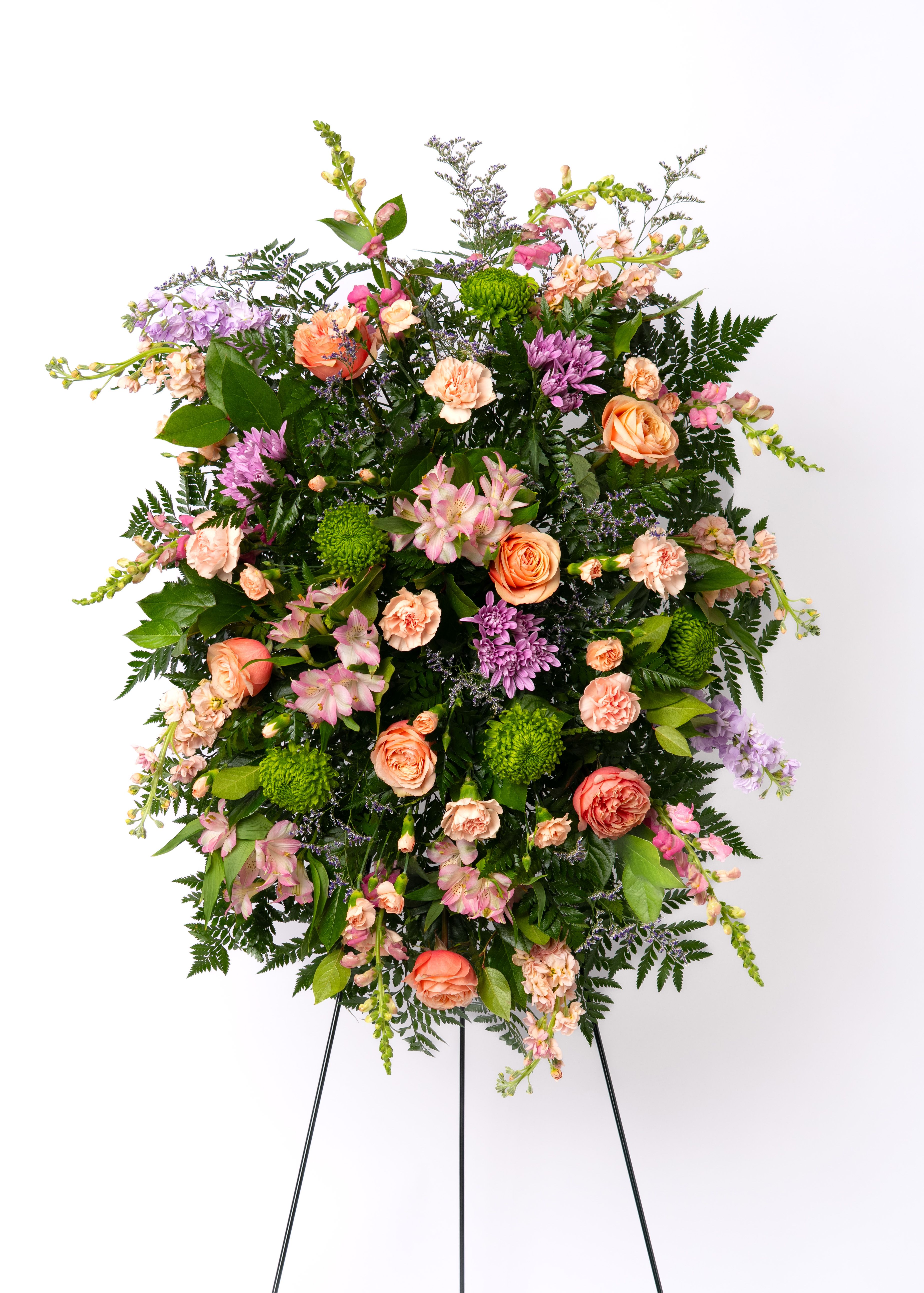Our Hope Collection: Diamond Easel Spray in Pastels - Soft and inviting, this pastel standing spray offers a gentle expression of sympathy. Designed with layered blooms in harmonious tones for a graceful presentation.  Each arrangement is thoughtfully designed using the freshest blooms available. Flower varieties may vary based on availability while maintaining the overall style, color palette, and value.  Approximate Dimensions of Floral Tribute: 72" tall x 28" wide on easel.  Color &amp; Customization: Need a custom color scheme? Contact us for more information. Our most popular palettes include whites, whites and greens, whites and blues, pinks and whites, pastel shades, and colorful designs.  Delivery: All sympathy pieces are hand-delivered by the Schultz Floral team.