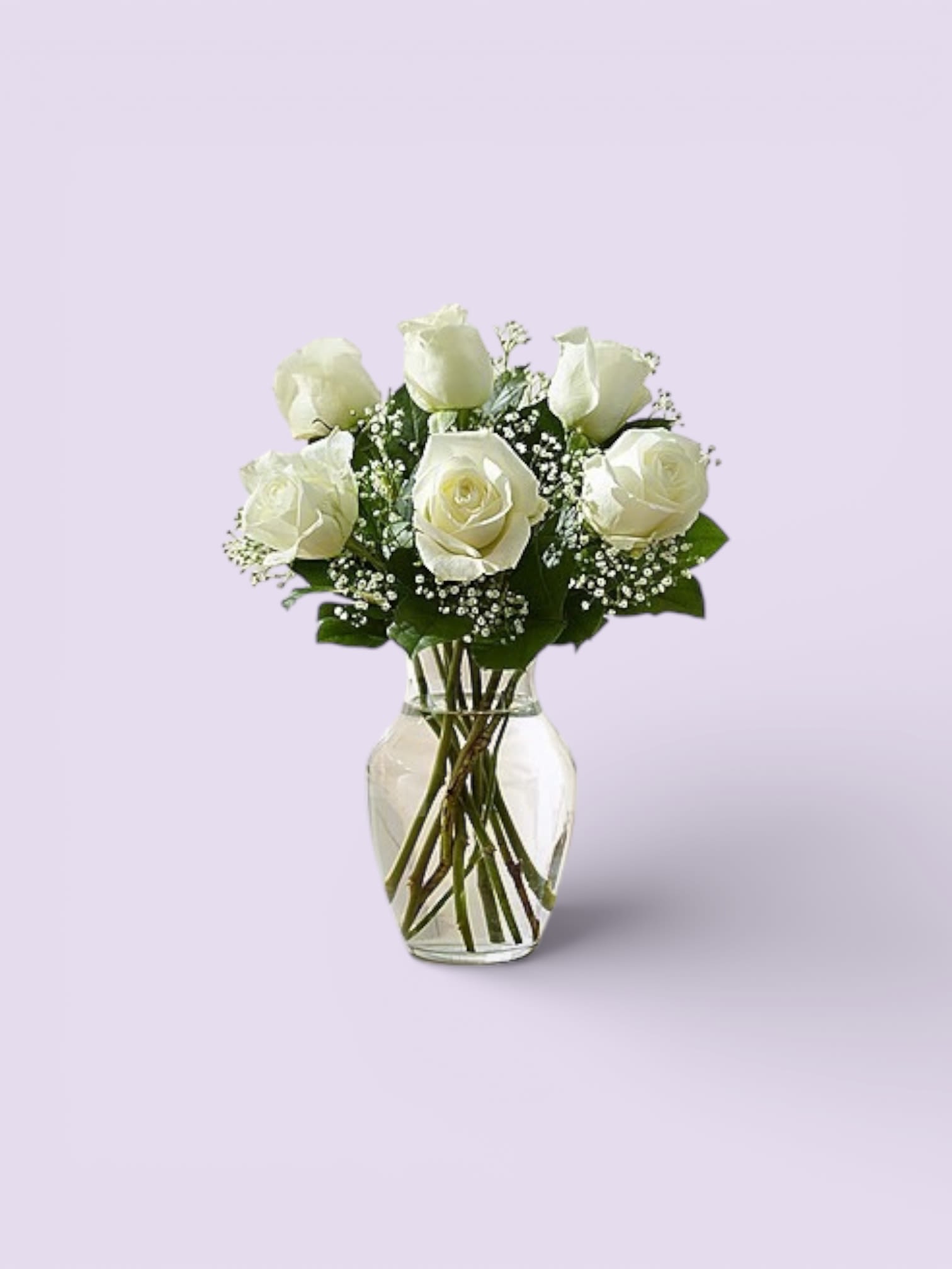 White roses arranged in a clear glass vase