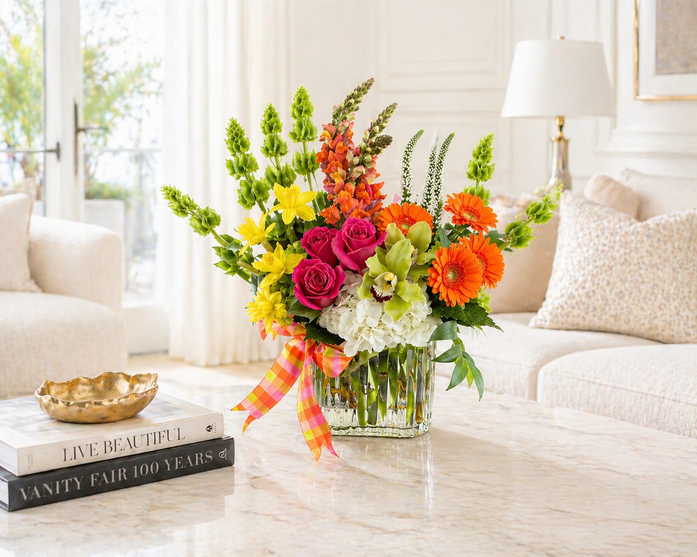 Super Cute - This fun and whimsical arrangement is bound to brighten anyone's day. Flowers included in this design are Bells of Ireland, Snapdragons, Roses, hydrangea, Gerbera Daisy's, Cymbidium Orchids, Veronica, and Daffodil's 