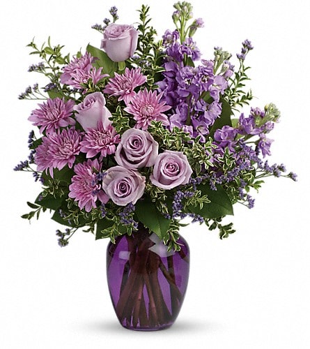 Together At Twilight Bouquet - Capture the magic of togetherness with this bountiful bouquet of enchanting lavender roses. Artfully arranged in a glass vase its twilight hues are sure to brighten anyone's day! This dramatic arrangement includes lavender roses lavender stock lavender cushion spray chrysanthemums lavender limonium oregonia and lemon leaf. Delivered in a purple glass vase.Approximately 15 3/4" W x 18 1/4" H Orientation: One-Sided