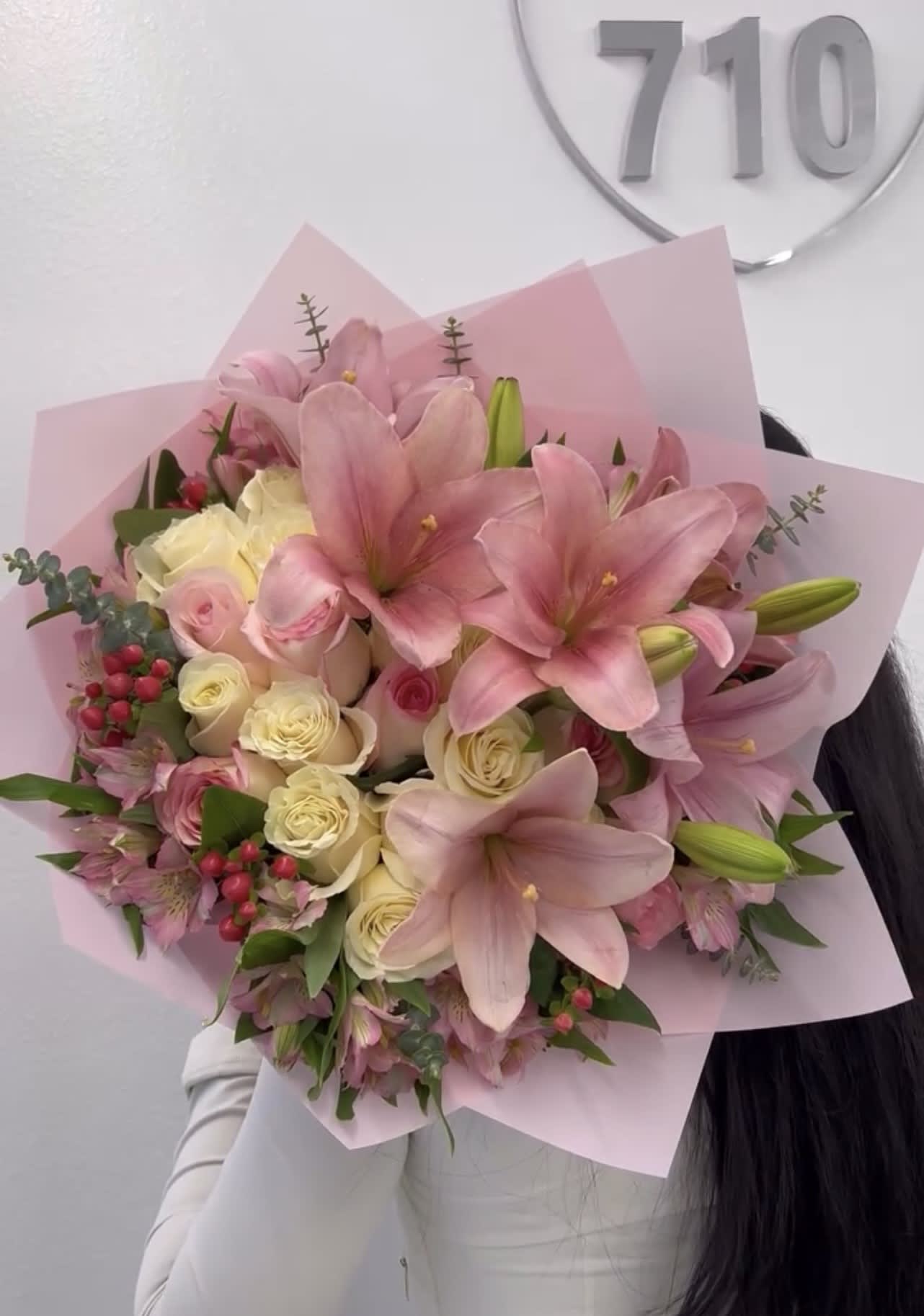 Pink lilies and cream roses in a wrapped bouquet