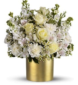 White rose and mixed white flower arrangement in a gold vase
