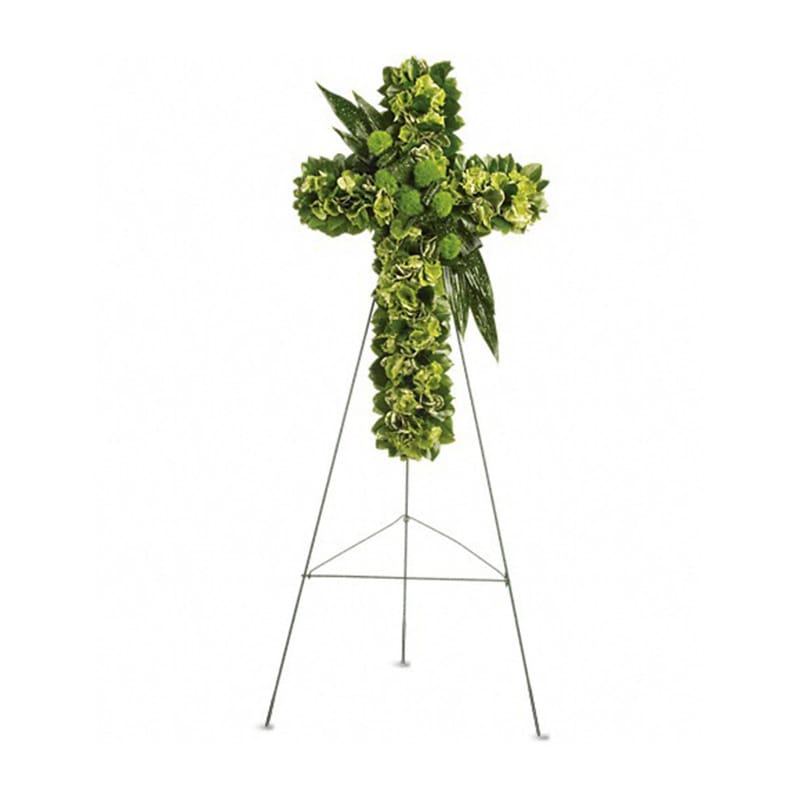 Standing cross of green flowers on a tall metal easel