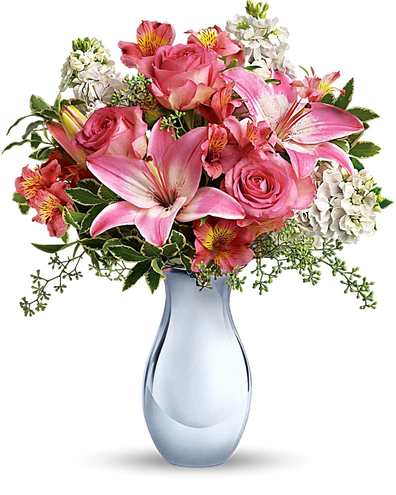 Pink roses and lilies arranged in a blue glass vase