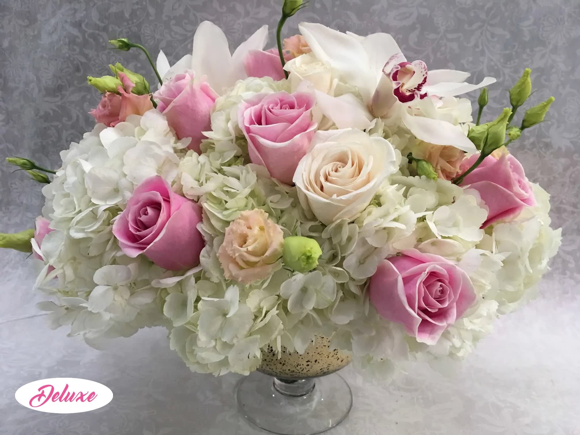 Pink and white rose arrangement in a glass vase