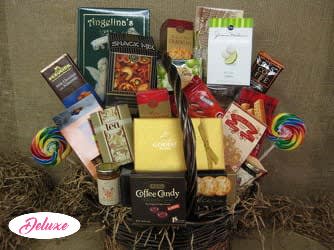 Basket of assorted snack and candy gift boxes with lollipops