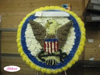 Circular floral tribute with an eagle and American flag design